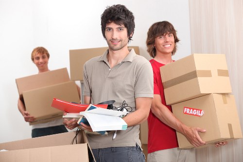 Local moving team transporting boxes and furniture