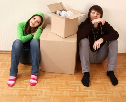Professional movers carrying furniture in an East London property